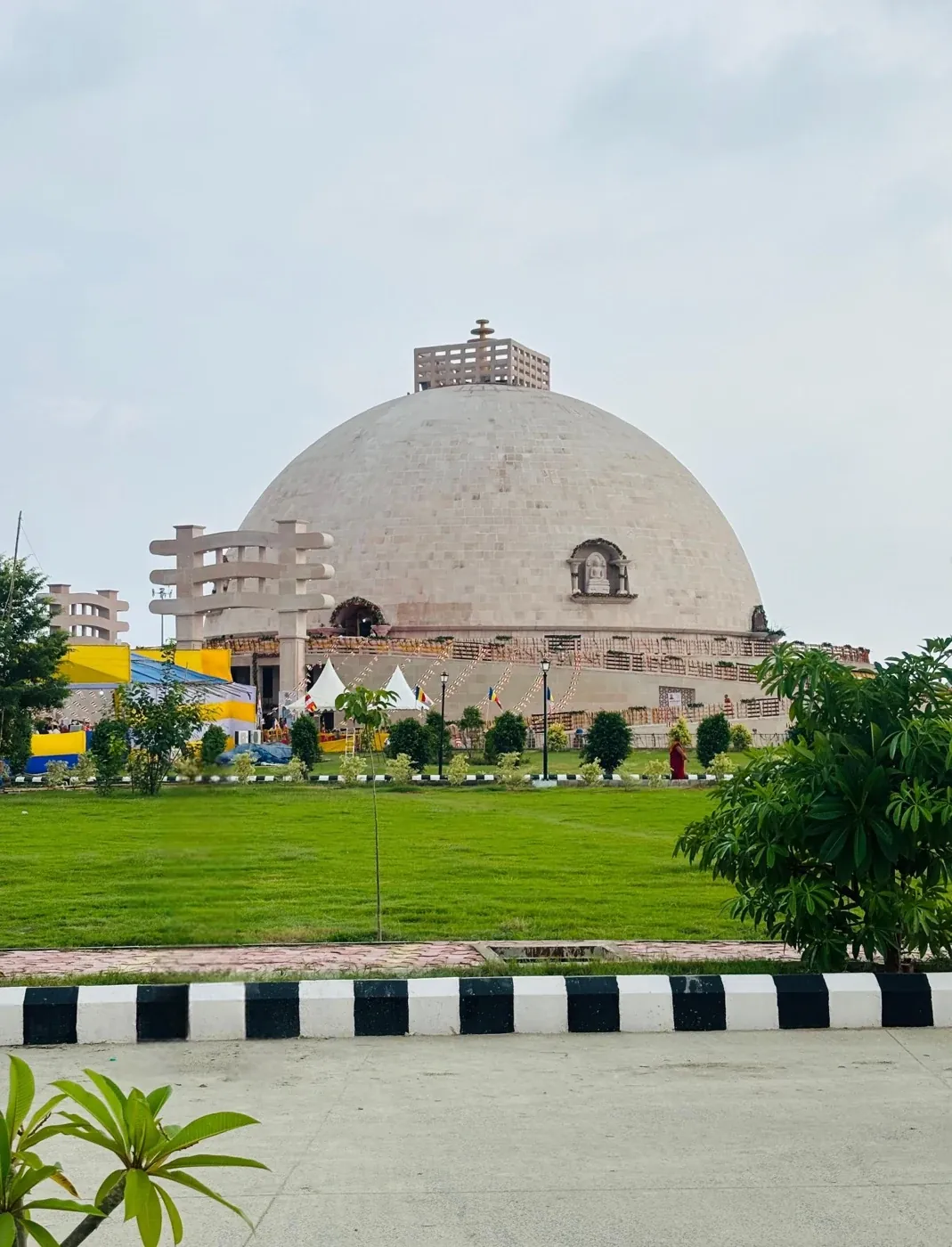 A domed sandstone museum building seen across landscaped gardens