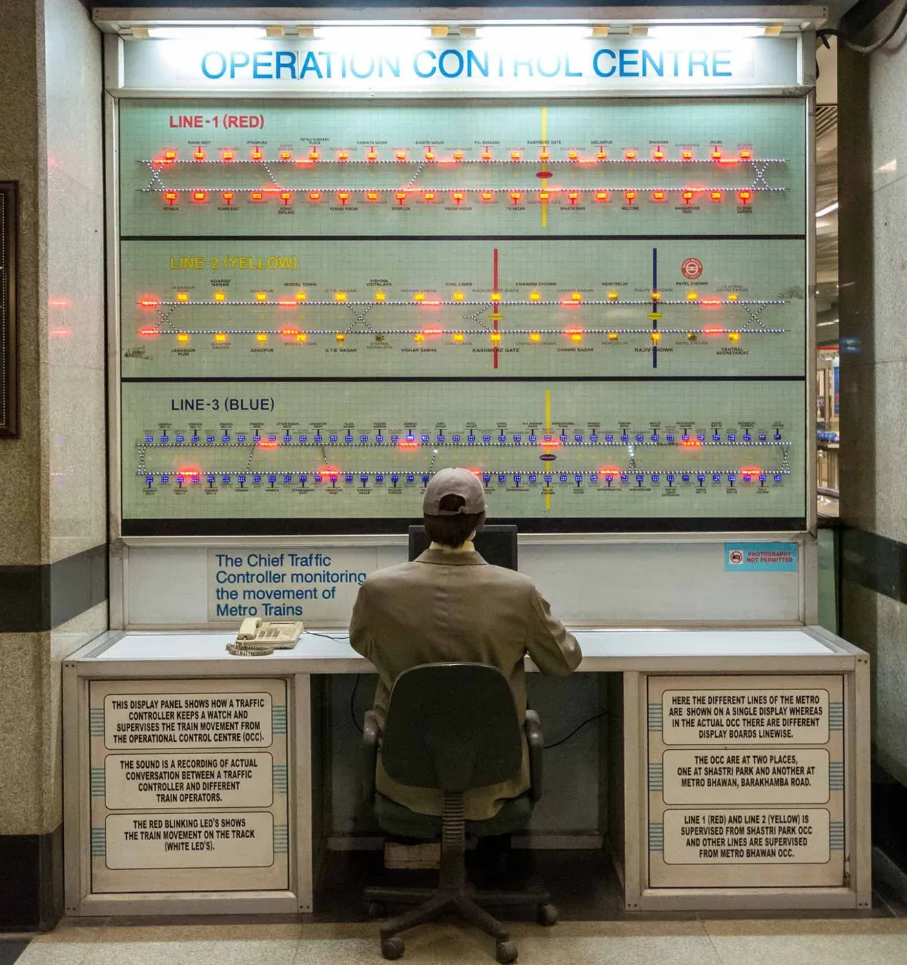 A visitor seated at an operations control display in the Delhi Metro Museum