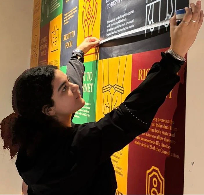 A researcher working on a colourful museum interpretation panel