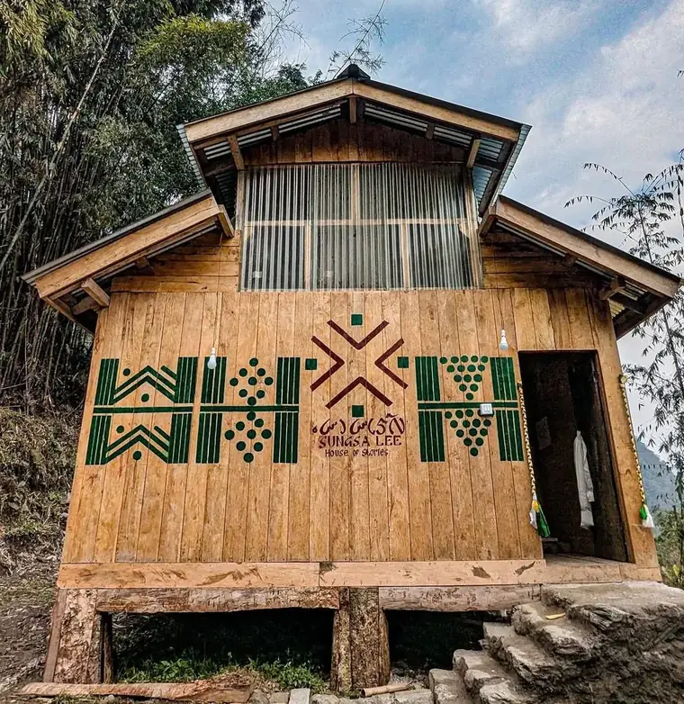 Bamboo-clad museum building decorated with green geometric patterns